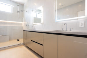 Modern minimalist bathroom with double shower system and elegant dual vanity sinks featuring clean lines and sophisticated design